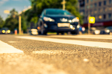 Summer in the city, the car go along the avenue. View from the pedestrian crossing level