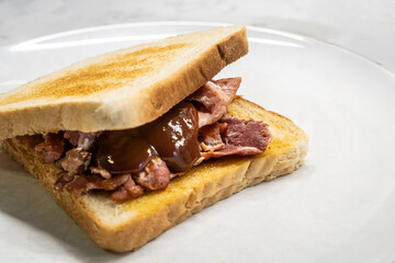 Bacon sandwich with brown sauce
