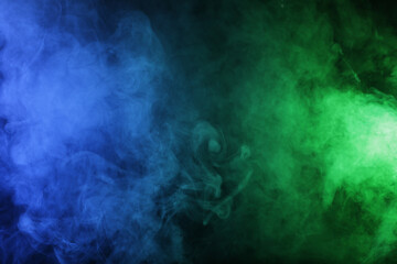 Fototapeta na wymiar Magic smoke in blue green light on black background