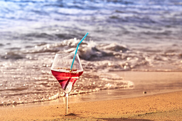 Wine glass with a cocktail by the sea.