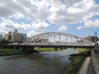 Fototapeta premium bridge over the river with blue sky and white cloud in the background