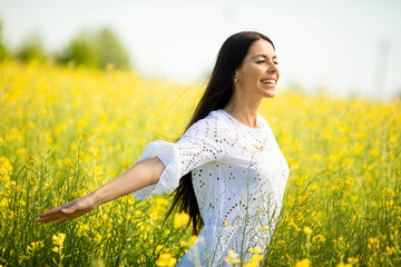 Young woman in the rapeseed field