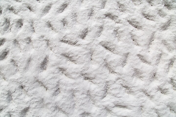 Background of gray painted relief wall with bumps and depressions of various sizes, rough finish. Backgrounds design textures.