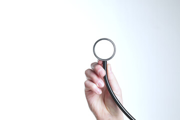 Doctor's hand holds a stethoscope in hand, isolated on white background