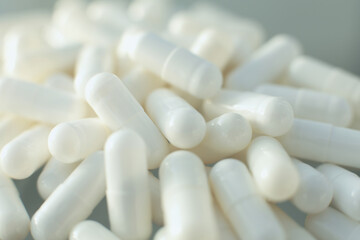 White medical pills on glass table. Close up