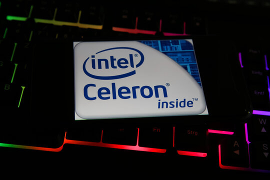 Viersen, Germany - May 8. 2021: Closeup of smartphone with logo lettering of intel celeron processor cpu on computer keyboard