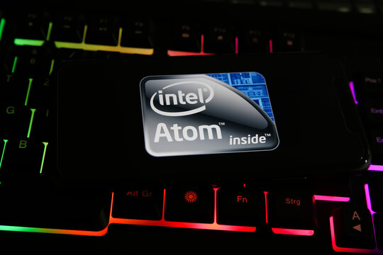 Viersen, Germany - May 8. 2021: Closeup of smartphone with logo lettering of intel atom inside cpu processor on computer keyboard