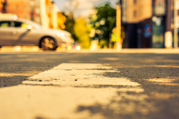 Summer in the city, the car passes by on the road. View from the pedestrian crossing level