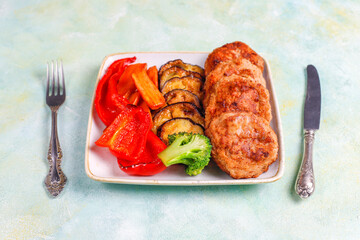 Homemade delicious cutlets with roasted vegetables.