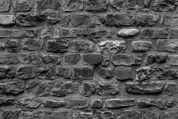 Old grungy clear retro brick wall of ancient city. Uneven soft pitted peeled surface brickwork of cellar worn. Ruined solid bumpy stiff blocks. Hard simple ragged holes brickwall for 3D grunge design