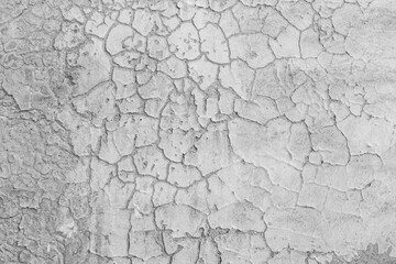 Old rustic grungy aged painted simple bleached facade. Rough edged wall. Wrinkled uneven flaked plastering. Cracked chipped bumpy falling stucco. Bright vintage flaking textured layer for 3D design