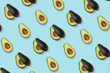 Avocado trendy  pattern on pasel blue background. Top view.