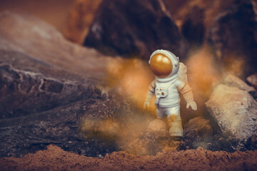 Determined Astronaut on rock surface with space background.