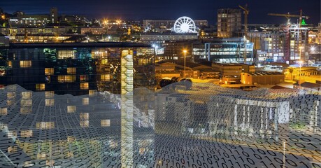 Composition of binary coding over cityscape at night