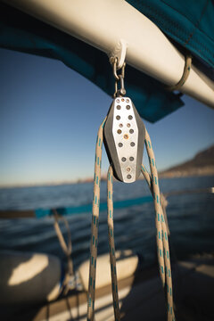 Ropes and pulley block on the mainsail of a boat at sea