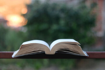 Open book in a garden. Selective focus.
