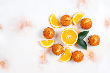 Homemade delicious orange muffins with fresh oranges.