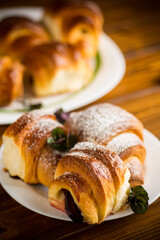 baked sweet homemade buns with plum inside