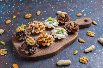 Various homemade mini tartlets with nuts and chocolate cream.