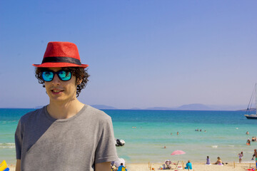 young boy in a red hat on the beach in summer	