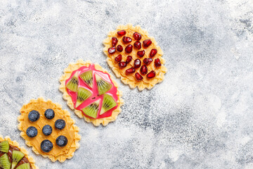 Homemade desserts with blueberries,kiwi slices and pomegranate seeds.