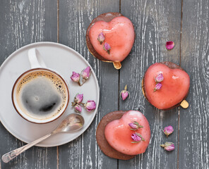 heart shaped mousse cakes with dry roses and a cup of coffee. romantic breakfast. valentine's and wedding concept. love and couple relationship.