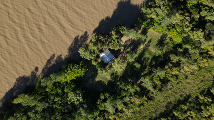High shot one house close to River and forest in South America