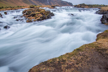 Flowing water and mini waterfalls in landscape long exposure in Iceland