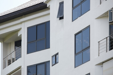 Fototapeta na wymiar Black aluminum windows frame of modern building. facade of a building