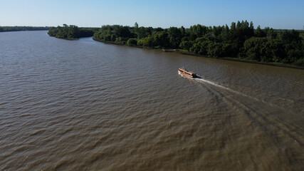 Tourist boat sailing through amazon river during sunny day.