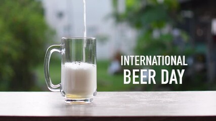 Concept, International Beer Day (IBD) is a celebration on the first Friday of every August founded in 2007. Pour beer into a glass and has beautiful white foam. Closeup, Blurred background