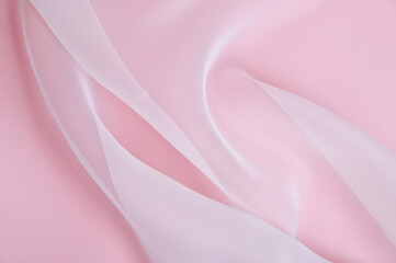 White organza texture background on a pink surface
