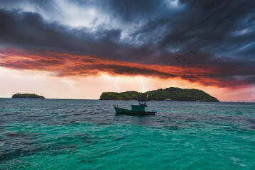 Fishing boat floating on a sea before a storm