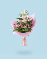 A bouquet of fresh  pink and white flowers. Creative pastel colored concept of lilies. Soft blue background.
