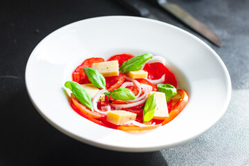 tomato salad vegetables cheese onions diet vitamins on the table healthy food meal snack copy space food background rustic. top view keto or paleo diet veggie vegan or vegetarian food