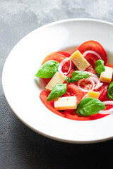 tomato salad vegetables cheese onions diet vitamins on the table healthy food meal snack copy space food background rustic. top view keto or paleo diet veggie vegan or vegetarian food
