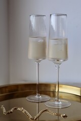 two glasses of champagne on a table