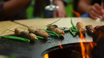 Snacks cooking on bbq grill outside. Meat and vegetables preparing for party