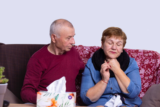 Gray-haired Man Caring For Sick Spouse At Home. Woman Having Cold And Sore Throat From Air Conditioner, Box Of Napkins On Table. Health Care Concept, Lovely Elderly Family