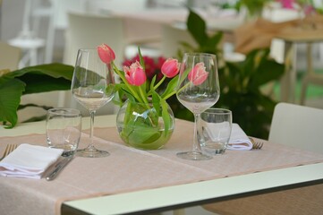 Rows of empty white restaurant terrace tables arranged for dinner