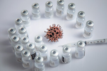 Microscopic Simulation Of COVID-19 Virus Pattern In Background Surrounded By Vaccine Vials
