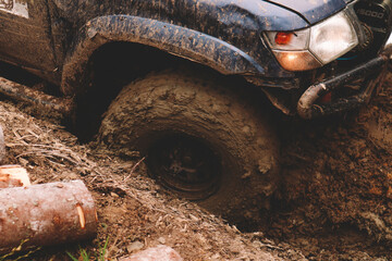 Dirty cars and wheels in the mountains. Swamp on the tires. Trips offroad across Ukraine. View of the Carpathian Mountains.