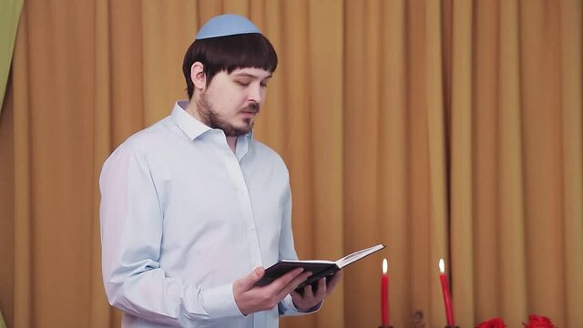Before the chuppah ceremony, the Jewish groom reads siddur prayers in the synagogue hall