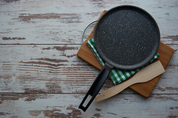 Kitchen utensils attachments: chopping board, frying pan, tea towel, wooden spatula. Copyspase
