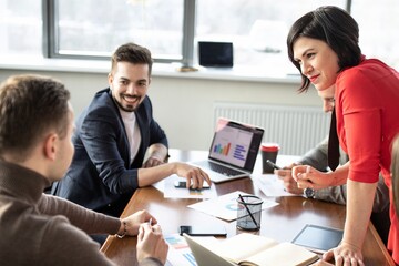 Meeting of businessmen, discussion of schedules. Business meetings, planning, negotiating.