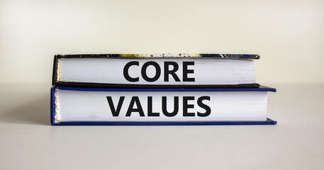 Core values symbol. Books with words 'core values' on beautiful wooden table. White background. Business and core values concept. Copy space.