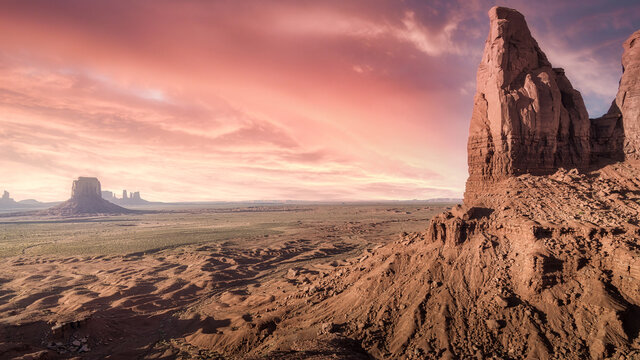 Spectacular scenery of tall rocky formations located in Monument Valley in America under colorful sky at sunset