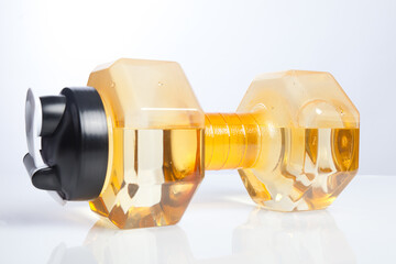 A yellow dumbbell which stuffed by water.