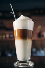Caffe latte layered with milk in a high drinking glass