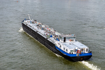 A large barge for the transport of liquid fuels sailing in Germany on the Rhine River....